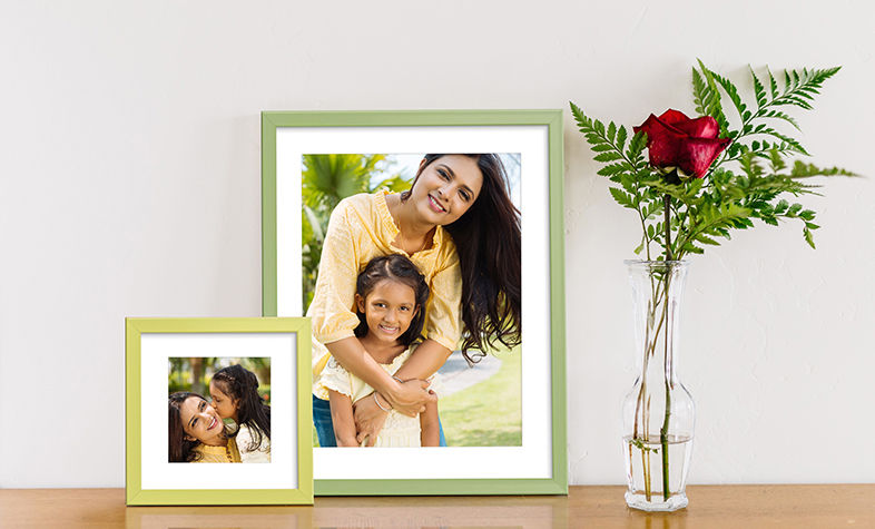 Coloured photo frames arranged as wall decor