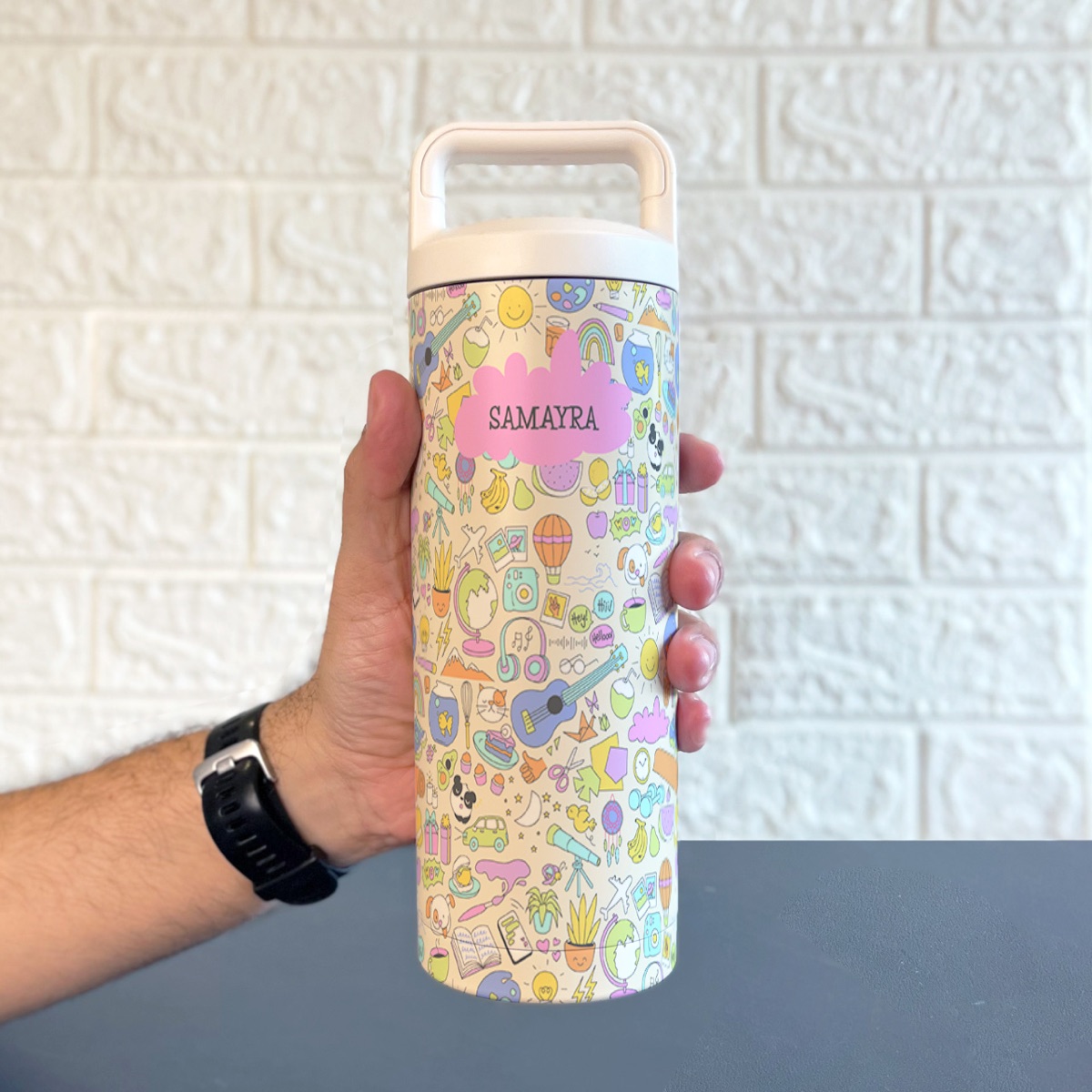Personalised water bottle printed with a name and colourful doodles